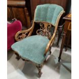 A Victorian walnut armchair with scroll arms, carved and pierced decoration, sea green upholstery
