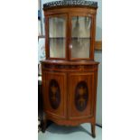 An Edwardian Sheraton style satinwood corner display cabinet