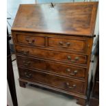 A reproduction crossbanded yew wood bureau with fall front, 3 long and 2 short drawers, width 51