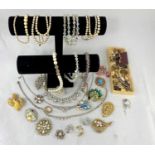 A selection of costume jewellery including necklaces, brooches etc