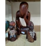 A carved wood figure of 'the thinking man' and a carved pair of African busts