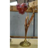 An Art Nouveau brass and copper table lamp with pink glass shade