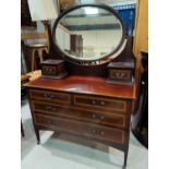 An Edwardian Sheraton style dressing table of 2 long and 2 short drawers, in crossbanded mahogany; a
