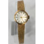 A 9ct gold Garrard ladies dress watch with bark effect strap, baton marks in Garrard box, gross