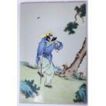 A Chinese porcelain tile with polychrome decoration of man walking with stick, 38 x 25cm