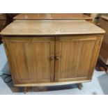 A 1960's Ercol stereo cabinet with hinged lid and 2 doors