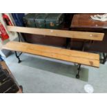 A 19th century bench seat with pine seat and back, cast iron supports