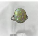 A white metal dress ring set large opal coloured stone, stamped 'PLATINUM', length of stone 17 mm