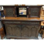 An Edwardian buffet sideboard with carved decoration comprising 2 cupboards over 2 drawers and