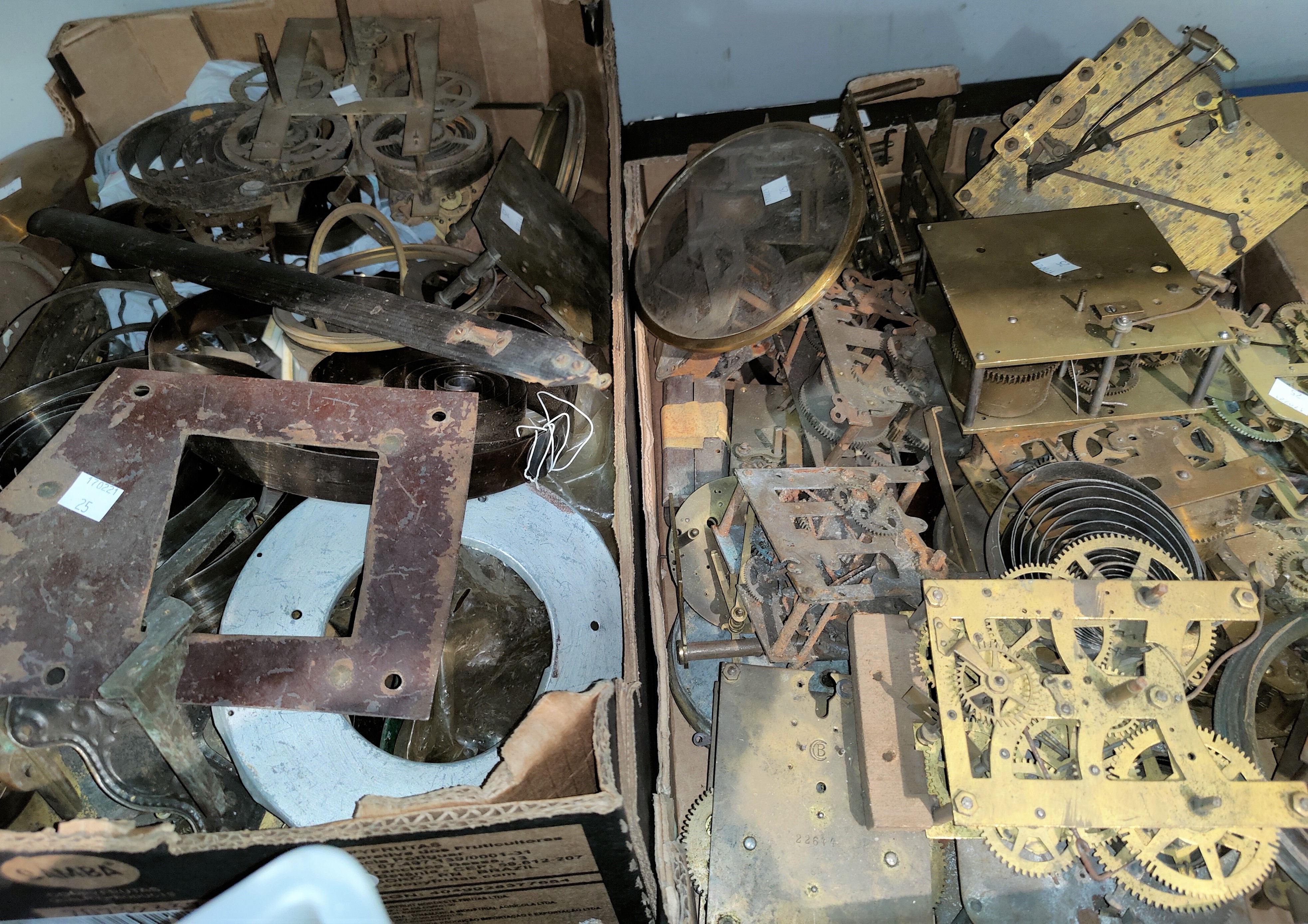 A selection of old clock parts; movements; springs; etc.