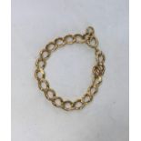 A yellow metal bracelet formed from flatted curb links, stamped '9ct', 19.6 gm