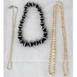 A cultured pearl graduating necklace; a simulated pearl necklace; a necklace formed from triple