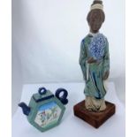 A Chinese ceramic figure of woman in robed and flowers, mounted on velvet stand, height 35cm and