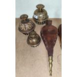 Three graduating Middle Eastern elephant claw bells and a set of wood and leather bellows