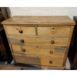 A Victorian stripped pine chest of 3 long and 2 short drawers with knob handles, on plinth base,