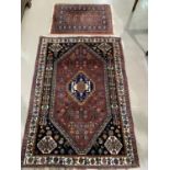 A modern hand knotted Persian rug with brown ground, length 148 cm; a similar smaller rug