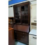 A 1930's oak bureau bookcase with twin glazed doors over fall front and 3 drawers, cabriole legs (