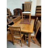 A modern light oak dining suite comprising extending table with rectangular top and 6 rail back