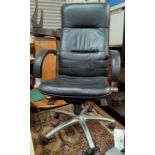 A vintage black leather effect and chrome high back executive chair