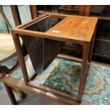 A 1970's teak and suede magazine table, 44 cm