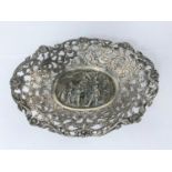 An oval continental cast whit metal bon-bon dish with pierced acanthus and flowerhead decoration