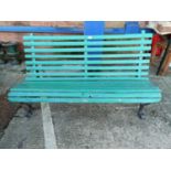 A 19th century slatted garden bench on curled wrought iron frame