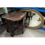 A gilt framed oval bevelled edge wall mirror; a canted 2 tier Art Deco oak occasional table