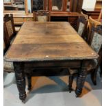 A Victorian carved oak dining table with carved edge and heavily carved legs 147 x 104 cms