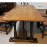 A late 19th early 20th century refectory dining table with a medieval style base with ring turned