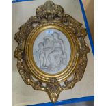 A reproduction relief wall plaque, woman and cherub, in ornate gilt frame