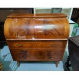 A reproduction mahogany cylinder bureau with 3 drawers underneath, surface stained