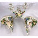 A pair of Capodimonte encrusted wall brackets; an encrusted mantel clock; similar china