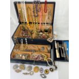 A large blue leather jewellery box containing a large selection of costume jewellery