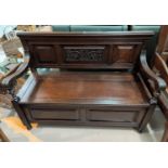 A 19th century carved oak hall settle with box seat