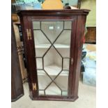 A 19th century mahogany corner cupboard with straight front, enclosed by astragal glazed door