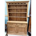 A stripped pine welsh dresser in the Victorian style with 3 height delft rack over 2 drawers and