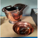 A 19th century copper coal helmet; copper dishes; etc.