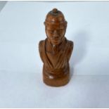 A carved wooden bust of a man in robes of officer, height 12.5cm