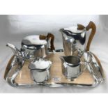 A Picquot ware four piece tea service with tray, polished hardwood mounts