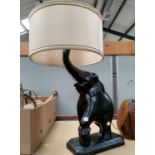 A large ebonised elephant table lamp