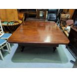 A Victorian rounded rectangular mahogany extending dining table with 1 spare leaf, on turned and