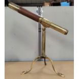 A reproduction brass table top telescope on tripod base