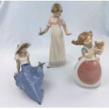 Three Nao figures - girl with candle, girl with pot of flowers, reclining girl with bird