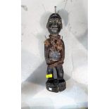 An African tribal carved wood fetish figure, applied nails and fibre rope, split at base 47cm