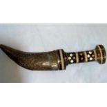 A vintage Middle Eastern dagger with inlaid hilt, embossed brass scabbard & Arabic script to the