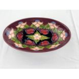 An oval Moorcroft dish decorated with pink flowers & fruit impressed & monogrammed length 23.5cm