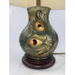 A Moorcroft baluster table lamp decorated with peacock feathers with shade height of base 19cm