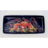 A red Moorcroft pen tray decorated in the "Finch" pattern impressed & monogrammed Length 20cm