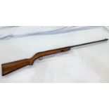 An air rifle with wooden stock stamped CA42717