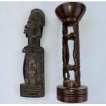 An African tribal carved wood figure 22cm; a hardwood candle holder 20cm